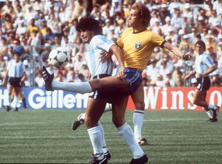 Brazil's Falcao kicks the ball away from Argentina's Diego Maradona at the 1982 World Cup in Spain.
