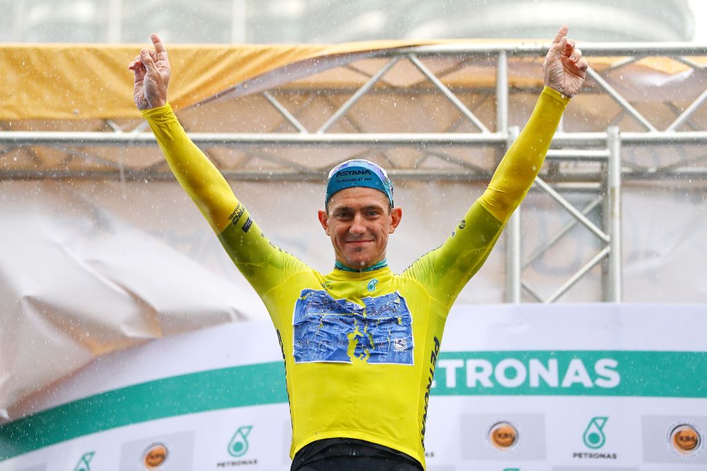KUALA LUMPUR MALAYSIA OCTOBER 11 Gleb Syritsa of Russia and Astana Qazaqstan Team celebrates at podium as Yellow leader jersey winner after the 26th Le Tour de Langkawi 2022 Stage 1 a 1573km stage from Kuala Pilah to Kuala Lumpur PETRONASLTdL2020 on October 11 2022 in Kuala Lumpur Malaysia Photo by Tim de WaeleGetty Images
