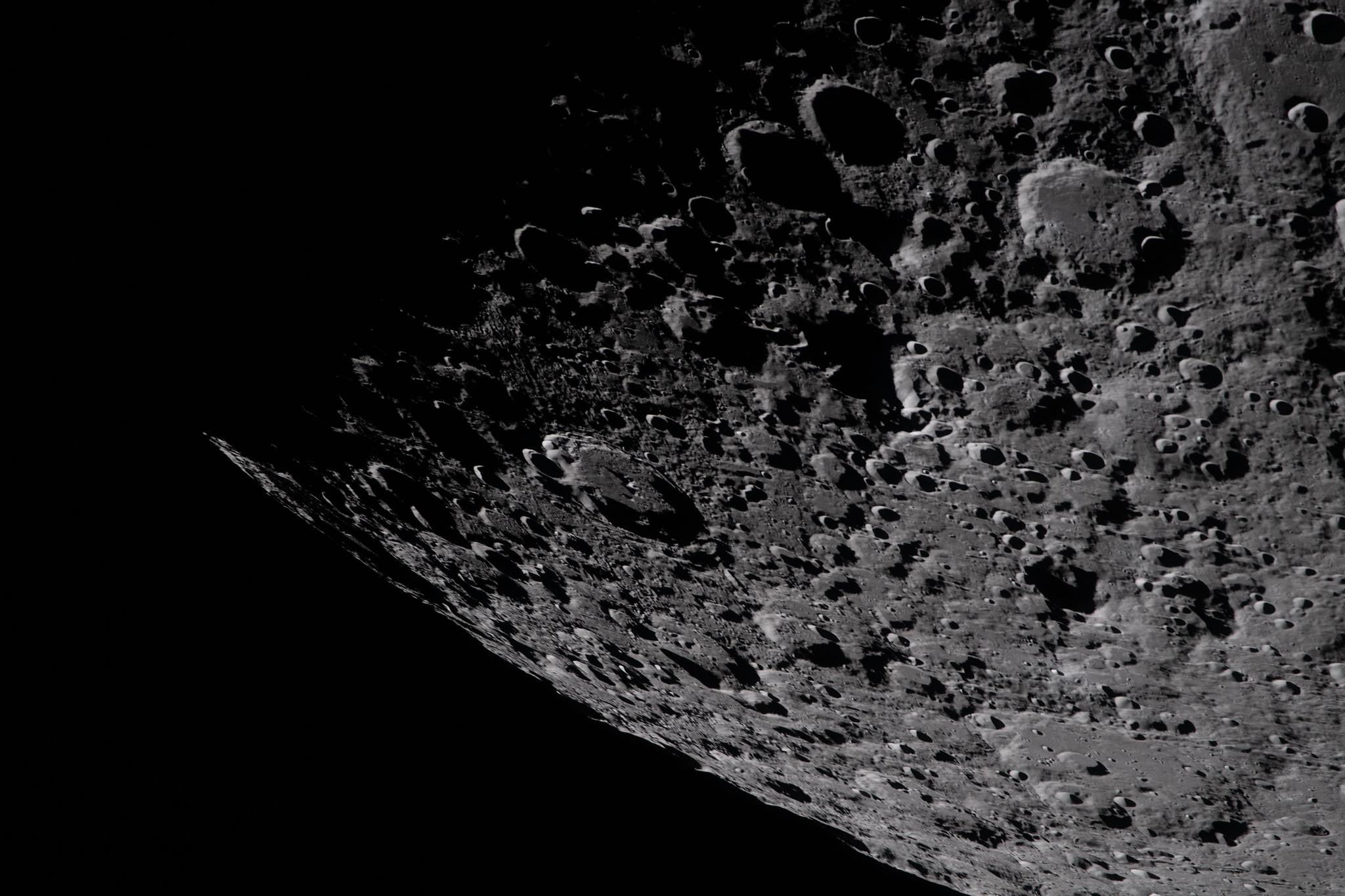 A close up of the moon's cratered surface.