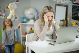 mother stressed trying to work when her kids are at home