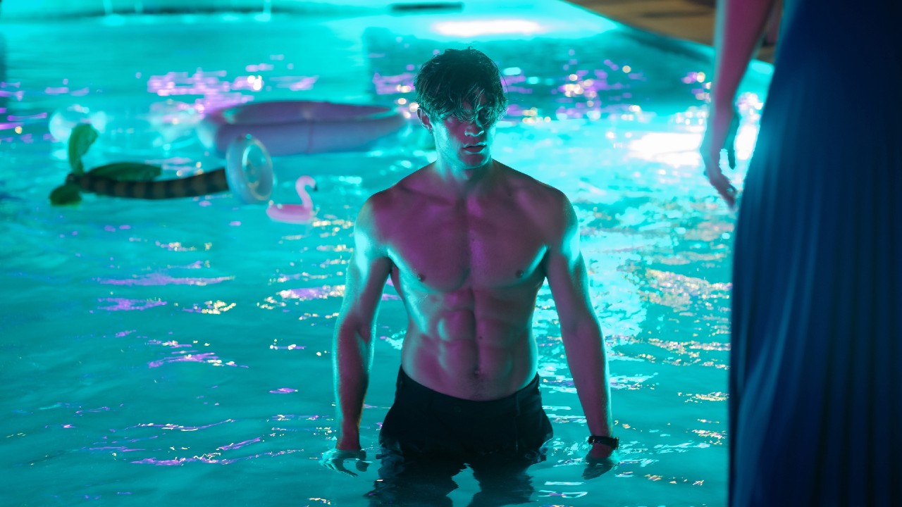 James standing in a pool.