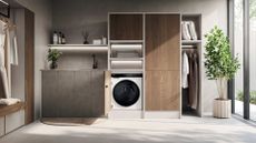 A utility room with a washing machine, and open cabinets for hanging clothes