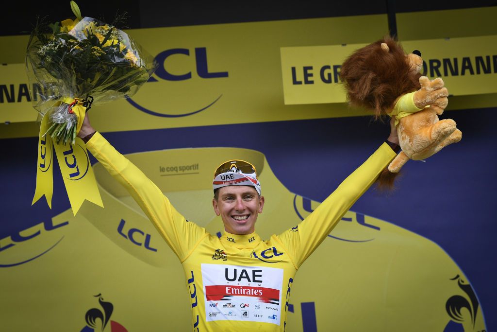 Tadej Pogacar of UAE Team Emirates celebrates on the podium in the yellow jersey of leader in the overall ranking after stage 8 of the 108th edition of the Tour de France 