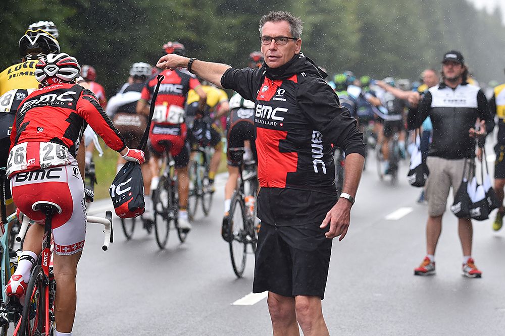 BMC staff handing out water bottles to his riders