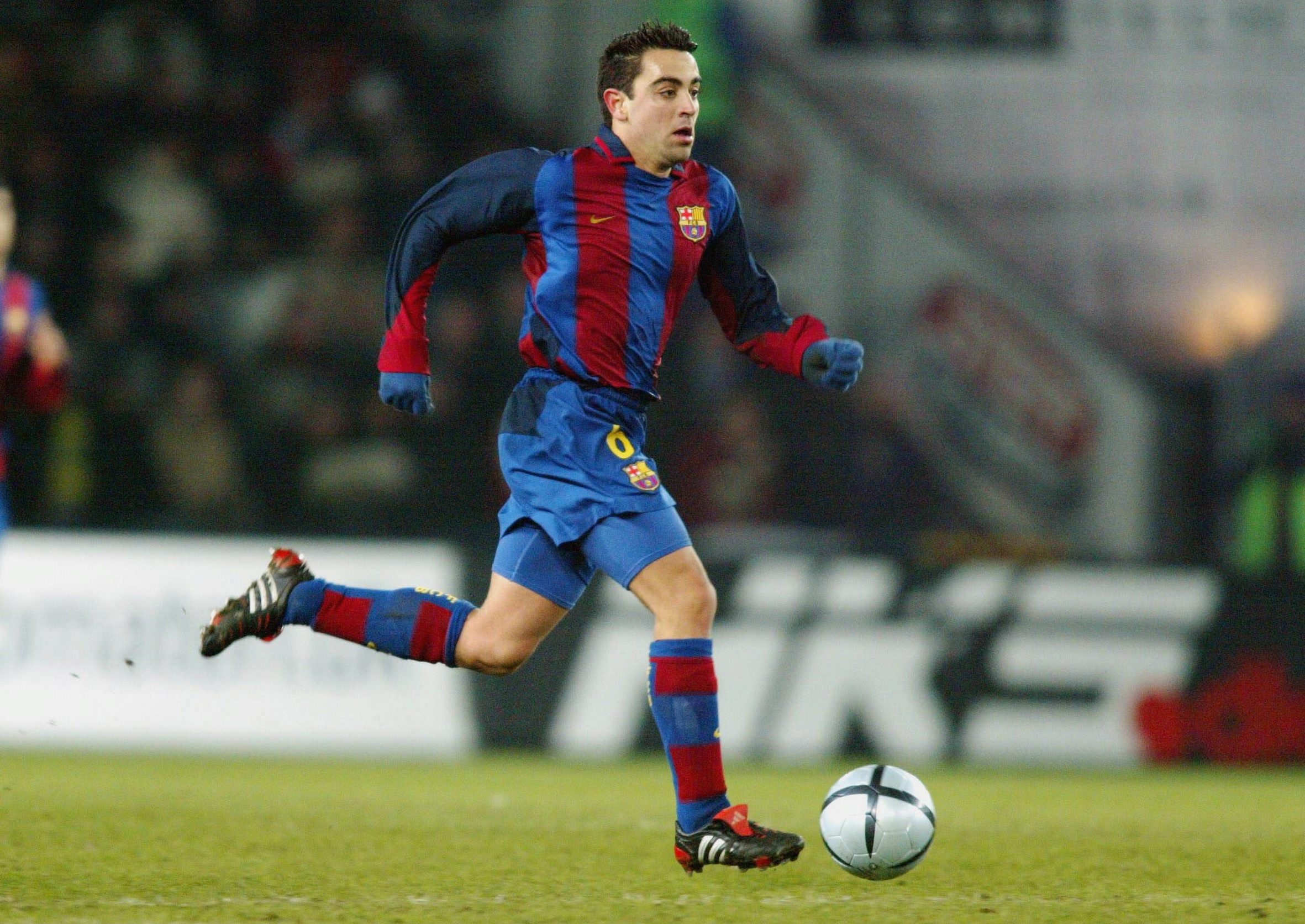 A young Xavi in action for Barcelona in 2003/04.