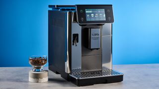 the de'longhi primadonna aromatic photographed against the blue tom's guide background