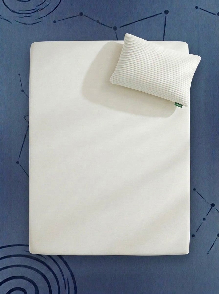 An Avocado Green Mattress Topper and Organic Pillow against a blue background of stars, edited by Gemini