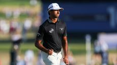 Aaron Rai celebrates holing a putt