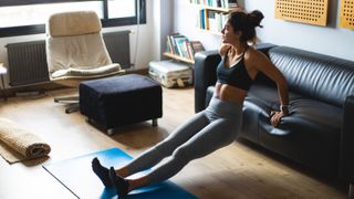 a photo of a woman working out at home using the best 30-minute workouts