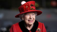 The Queen smiles in red 