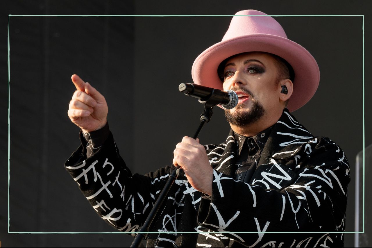 Boy George on stage singing into a microphone