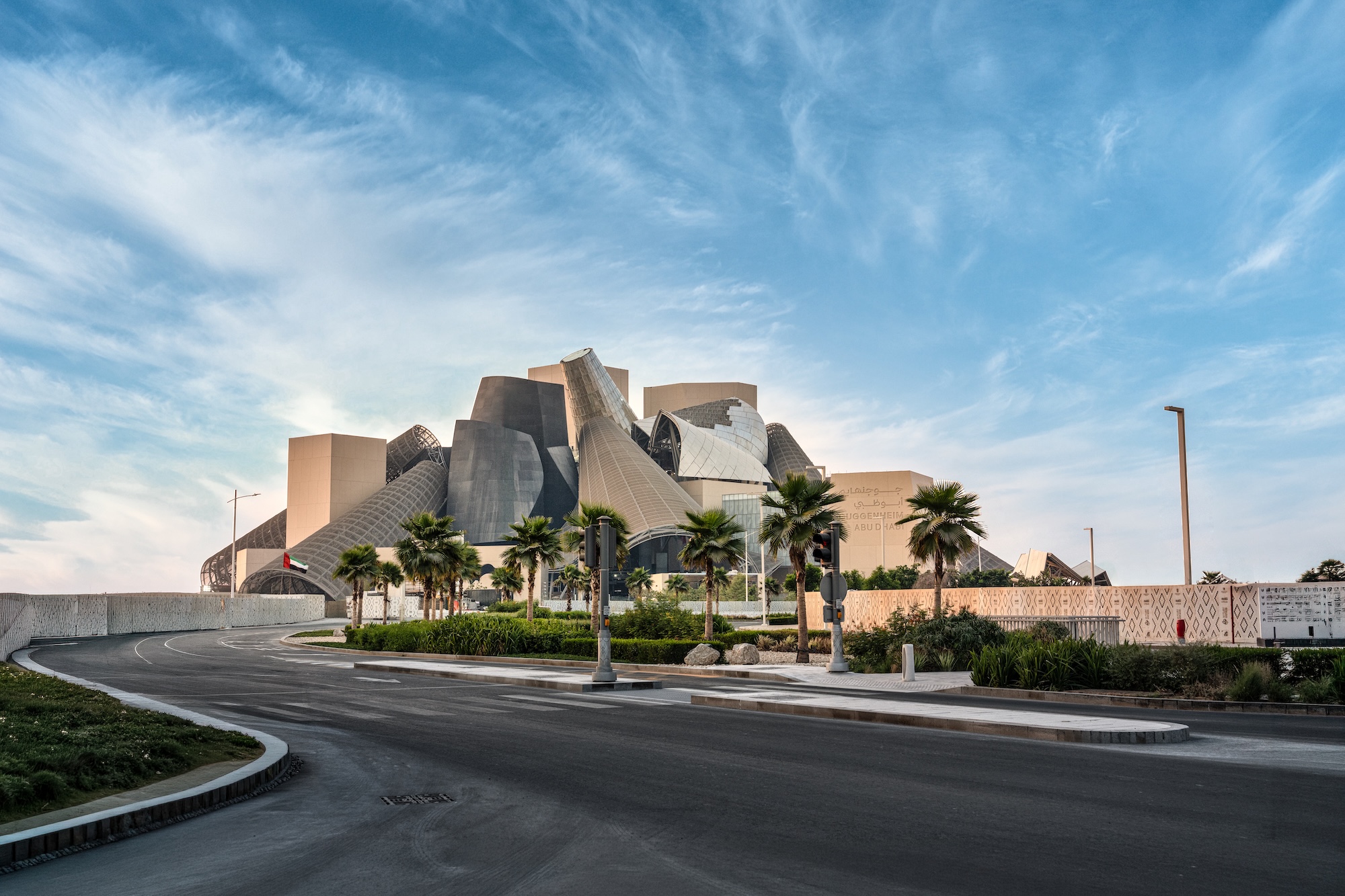 Guggenheim Abu Dhabi exterior images featuring a geometric assemblage of volumes made from steel glass timber and stone
