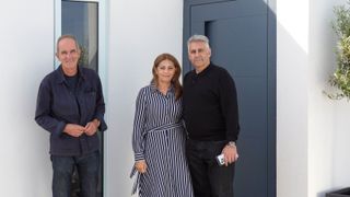 Kevin McCloud with couple outside white building