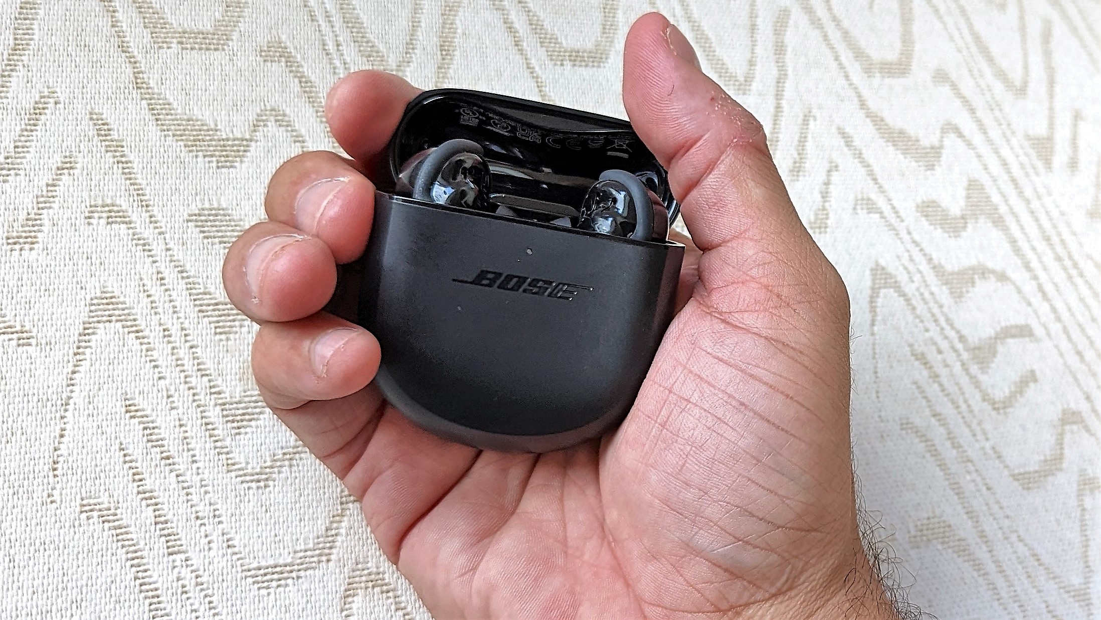 Bose QuietComfort Earbuds 2 in reviewers hand