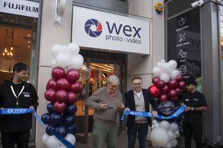 Photo of photographer Martin Parr cutting the tape to open the Putney branch of Wex Photo Video