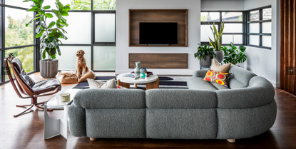 A living room couch with a colorful pillow