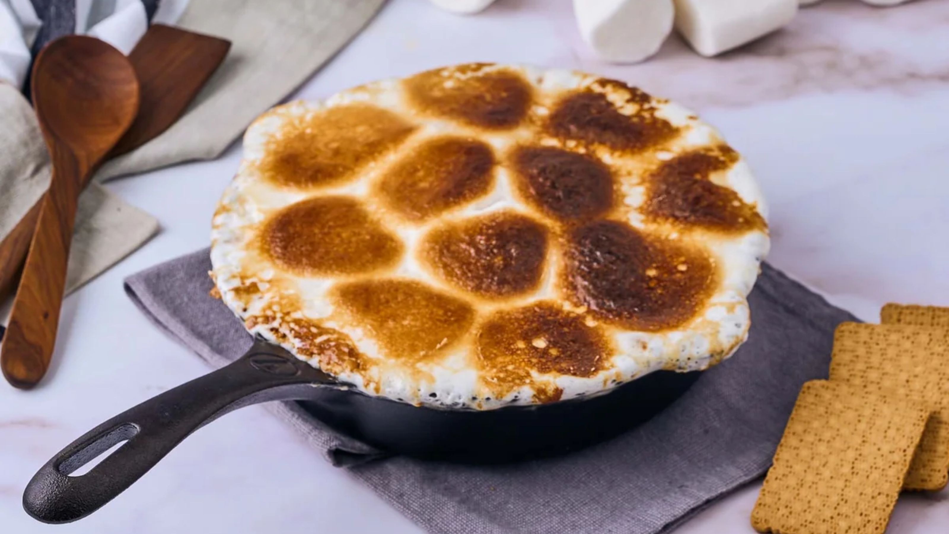 A browned marshmallow topping in a black cast iron skillet