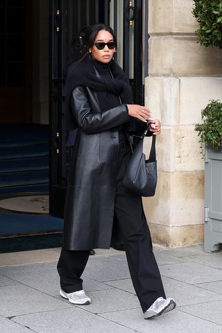 Laura Harrier wearing a leather coat and chunky sneakers in Paris