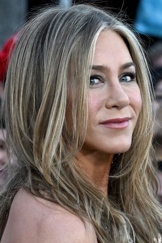 Jennifer Aniston is pictured with grey hair whilst attending the Los Angeles Premiere Of Netflix's "Murder Mystery 2" held at Regency Village Theatre on March 28, 2023 in Los Angeles, California.