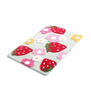 A strawberry and flower patterned rug