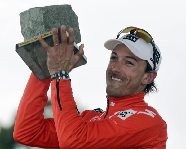 Fabian Cancellara (Saxo Bank) holds his cobble aloft on the Paris-Roubaix podium