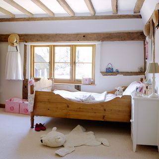 childrens room with wooden sleigh bed and table lamp