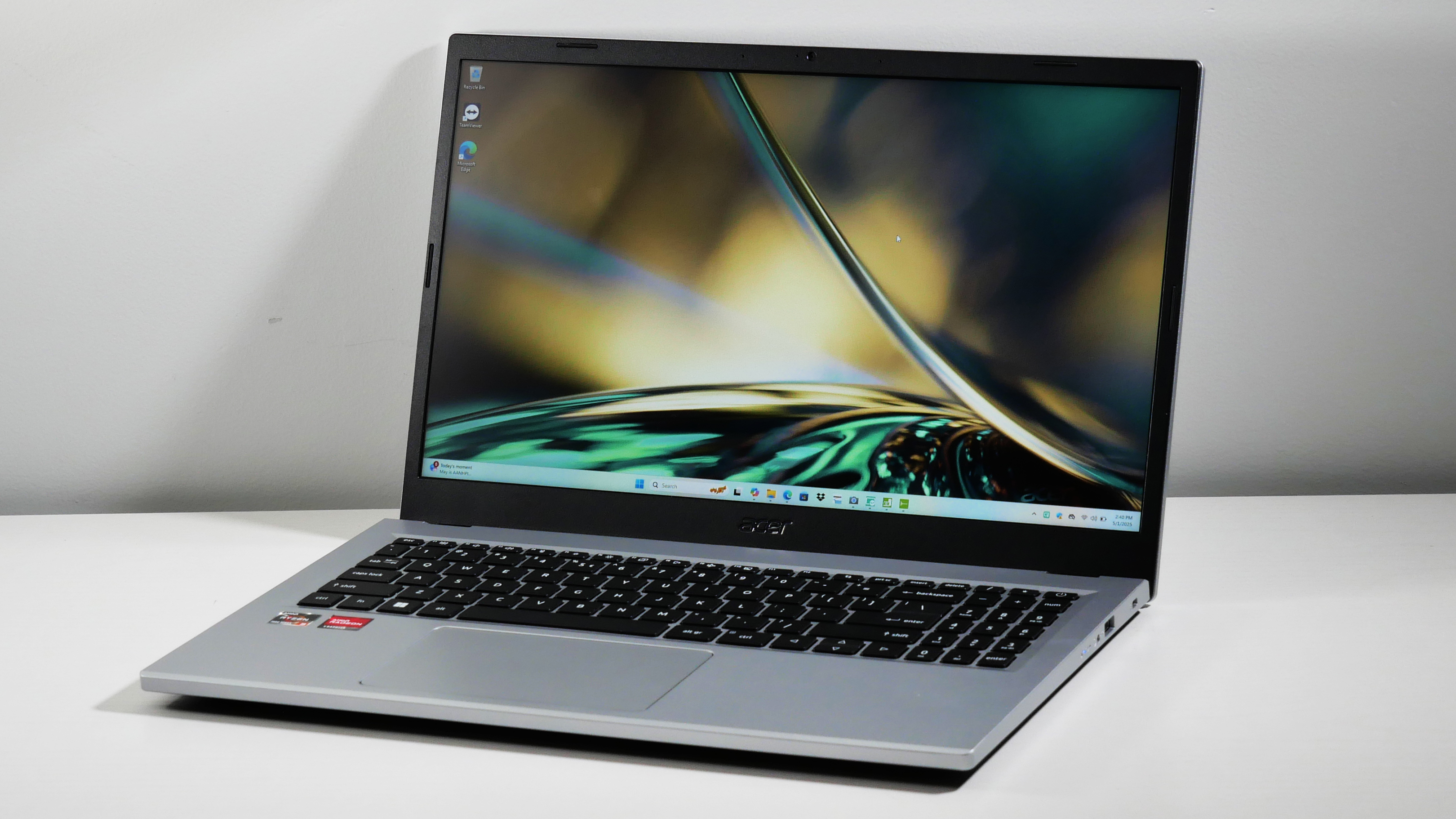 Acer Aspire 3 15 open at an angle on a white desk.