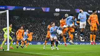 Manchester City's Swiss defender #25 Manuel Akanji (C) heads the ball during the UEFA Champions League football match between Manchester City and Real Madrid at the Etihad Stadium in Manchester, north west England, on February 11, 2025.