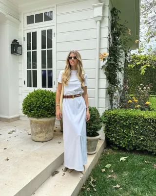 sofia richie posing wearing a white t-shirt dress and tan belt