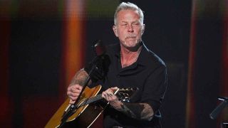 Metallica’s James Hetfield playing an acoustic guitar onstage