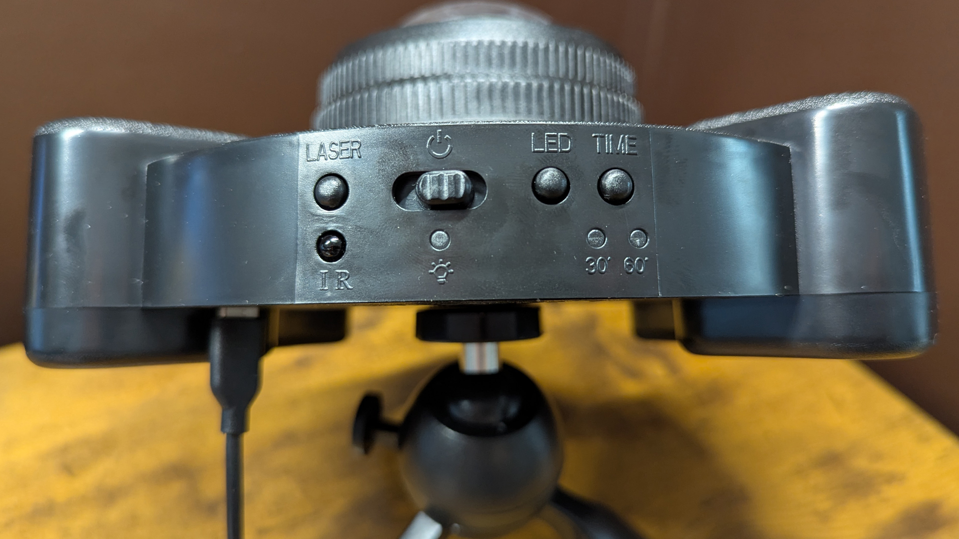 YgiTK Northern Galaxy Lights Projector during Review, on a wooden table against a dark coloured wall