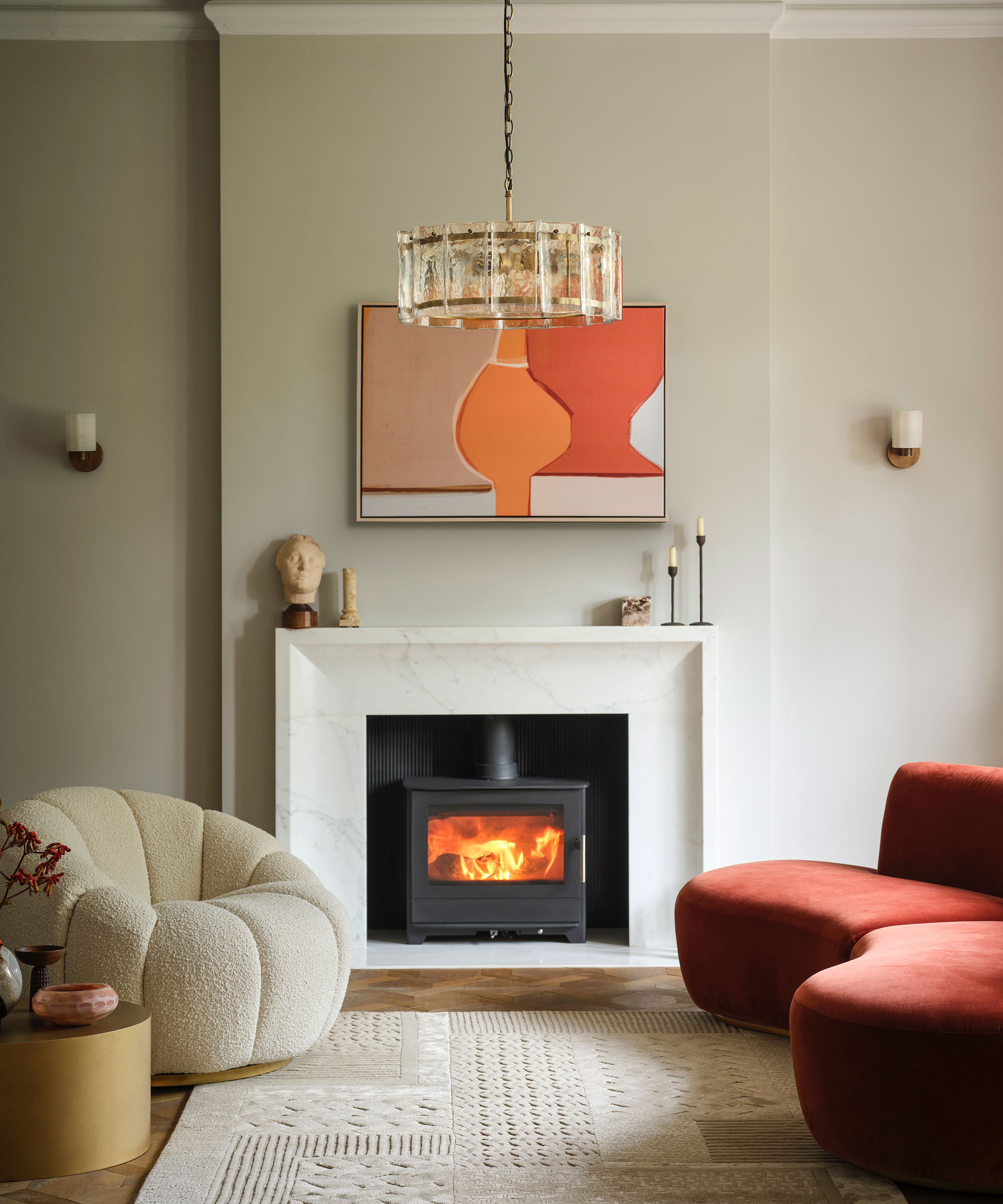 modern living room with log burning stove with glass chandelier