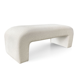 A cream boucle bench with rounded arch edges and modern geometric look