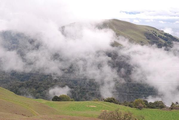 Low clouds hug the hills.