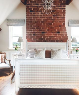 brick wall, gingham bed, white bedside tables