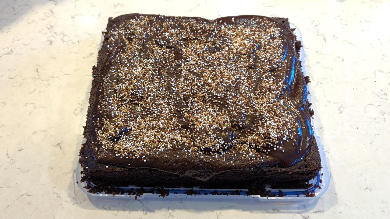 Chocolate cake baked using Ninja Crispi Microwave, decorated with frosting and sprinkles