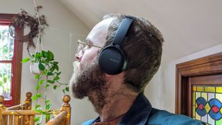 Someone wearing the Sony WH-CH510 on-ear headphones in black