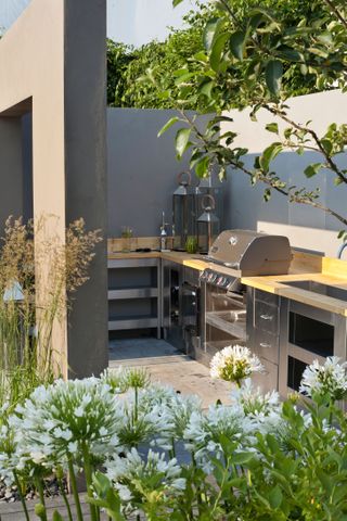 An outdoor kitchen surrounded by plants