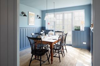 blue dining room with dark wooden furniture