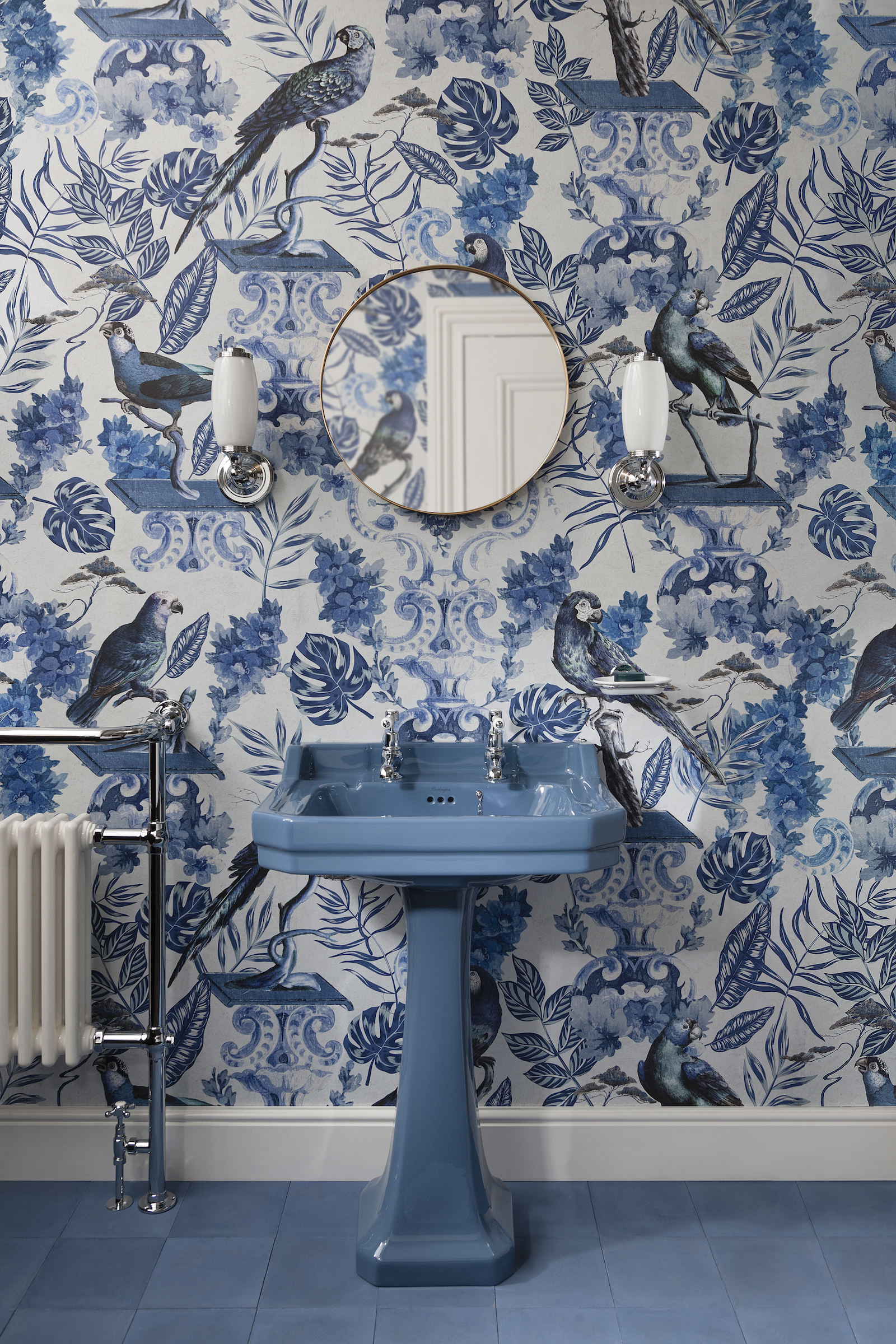 blue bathroom basin and blue and white wallpaper