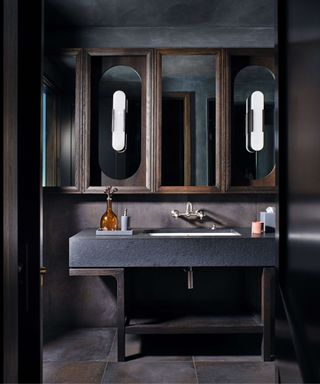 Dark bathroom with large mirror