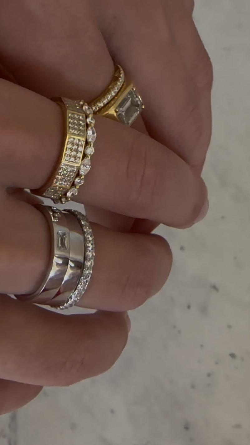a close-up of Larissa Mills wearing a stack of gold and silver diamond rings