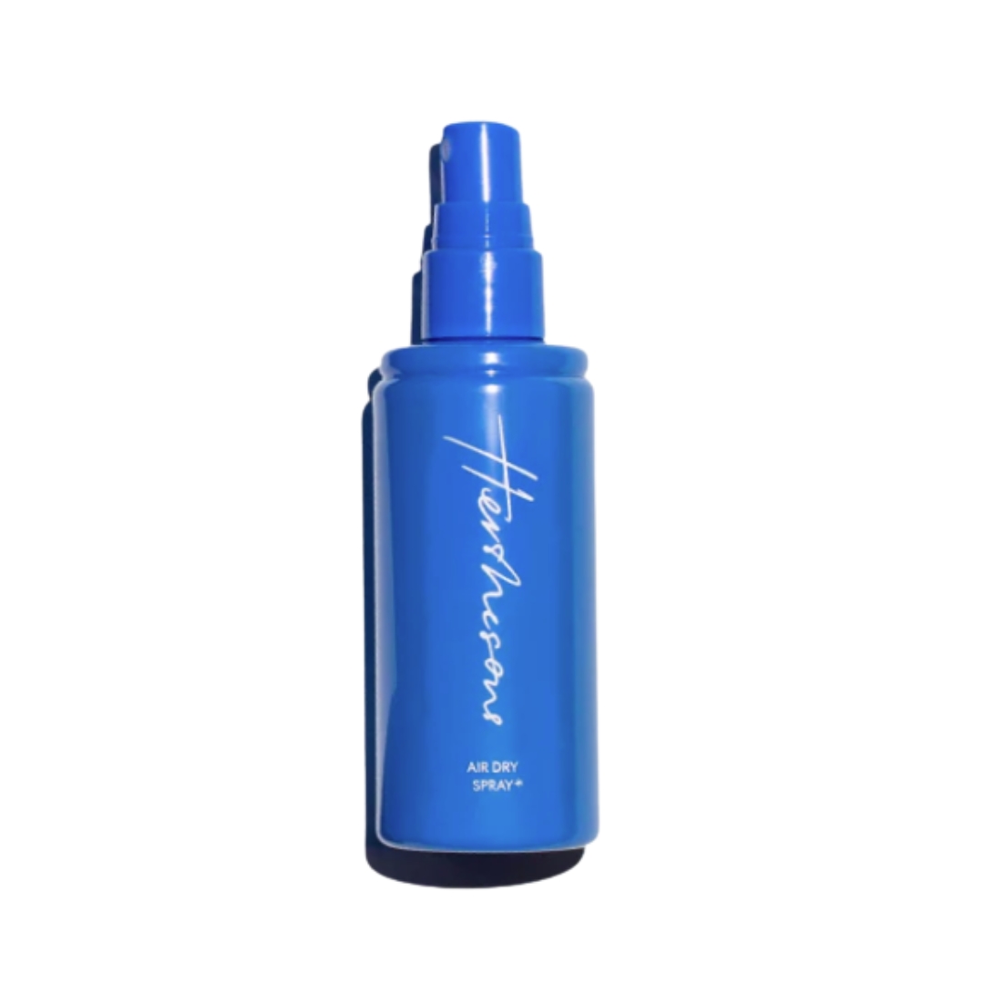 A product shot of the Hershesons Air Dry Spray, which has a bright blue bottle, pictured on a white background