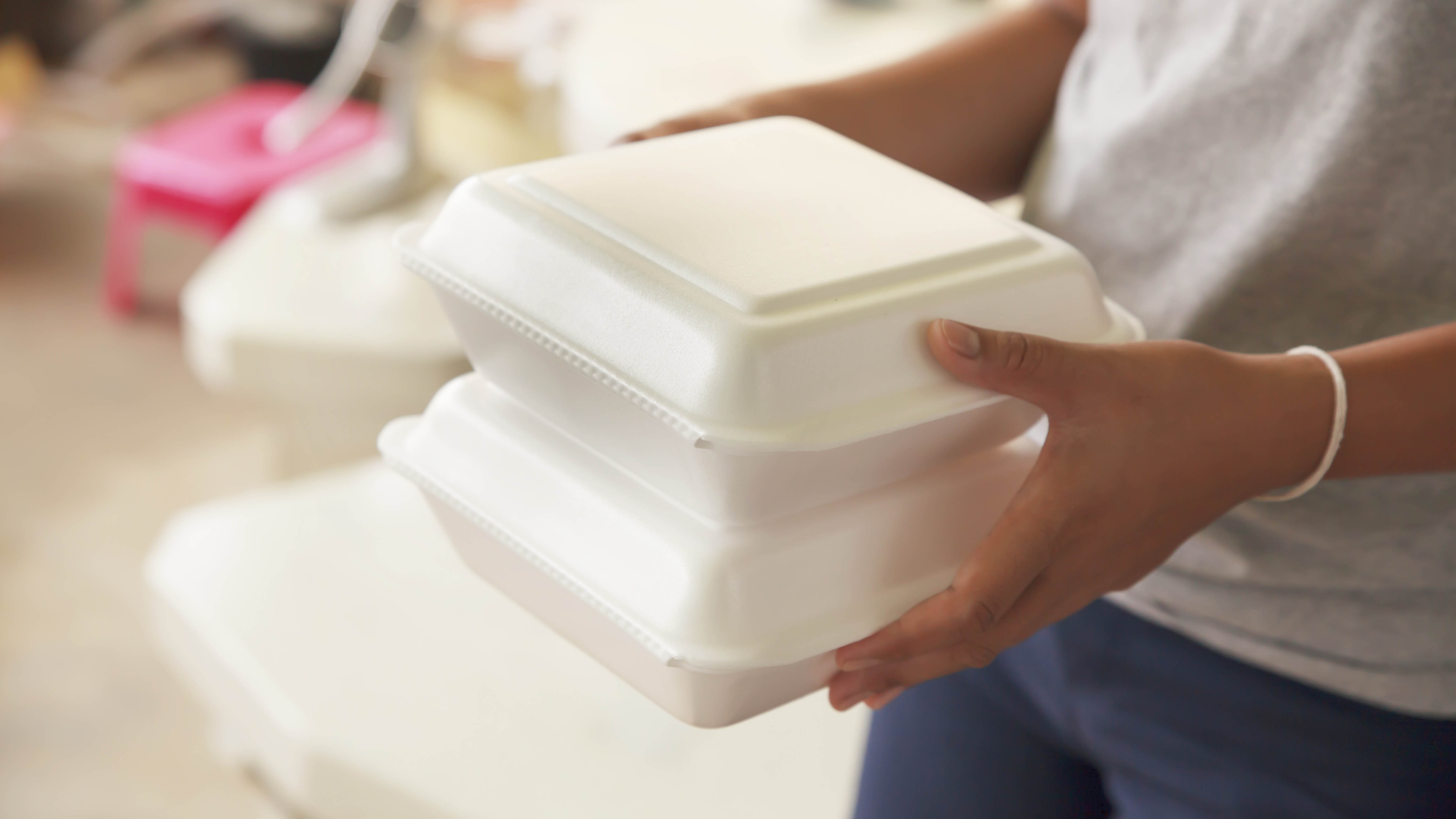 Woman holding styrofoam containers