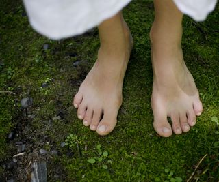 Woman's bare feet on moss