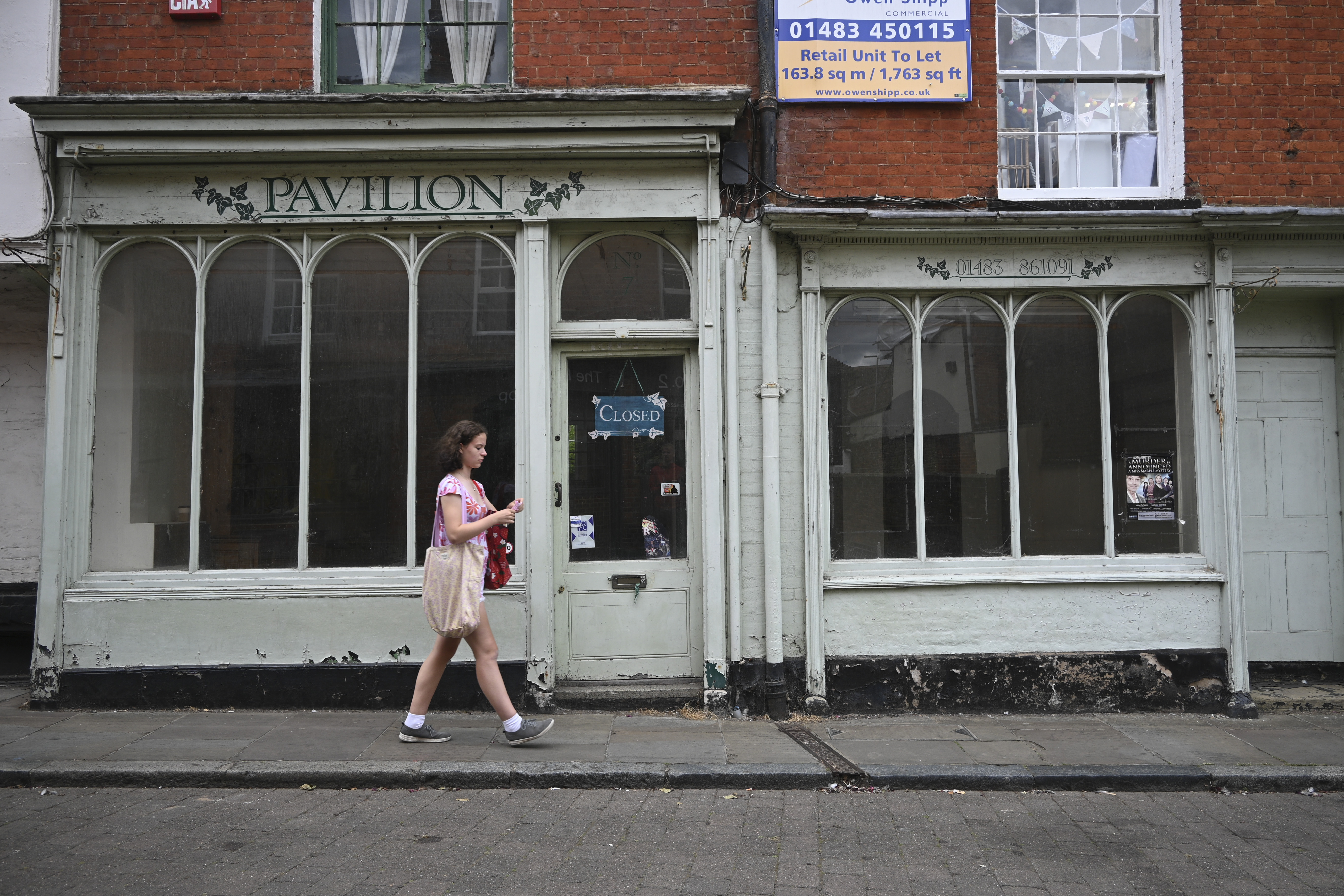 Nikon Z30 photograph of a woman walking in front of a shop