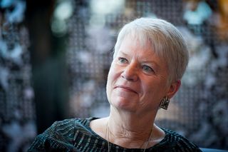 Jill Tarter smiles and looks off camera to her right.