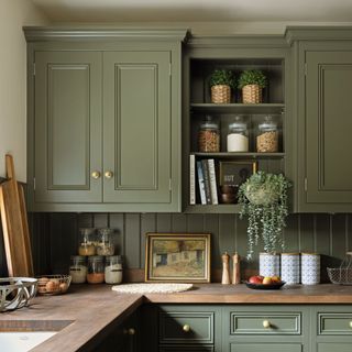green kitchen with wood panelling