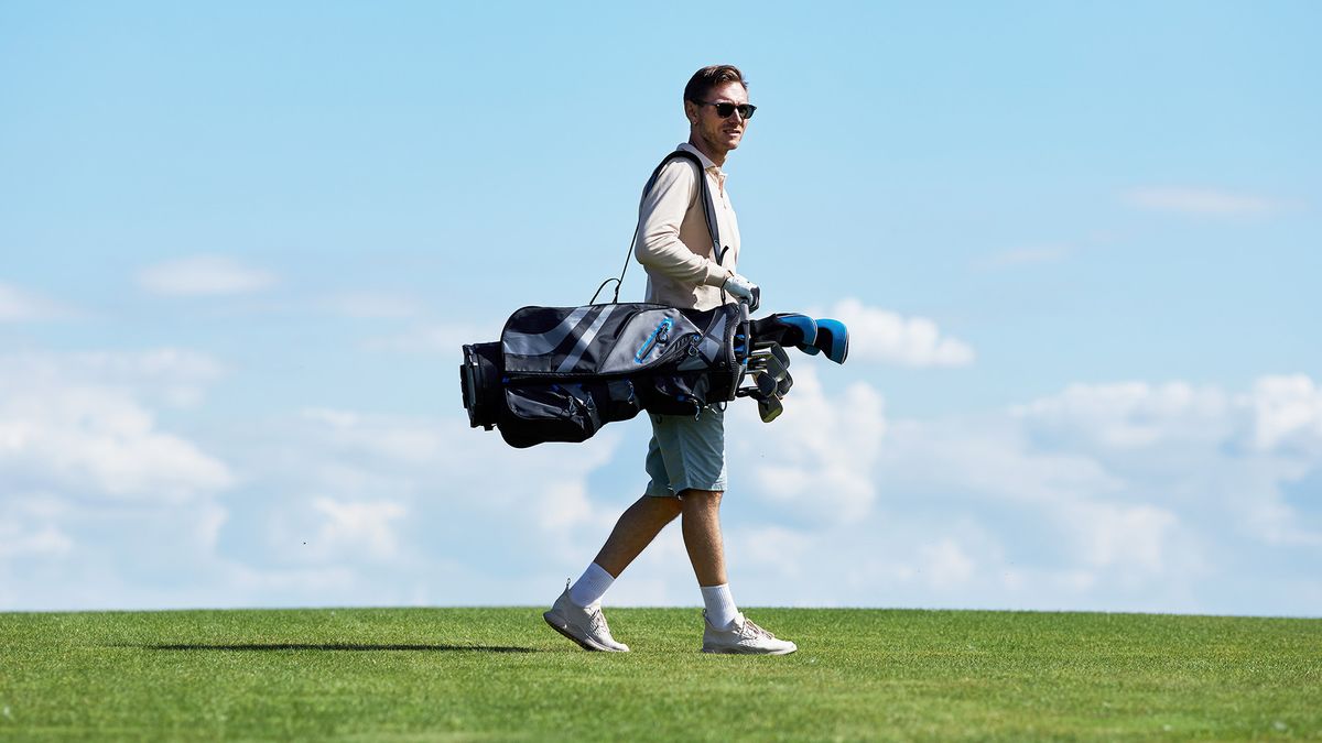 A man walking with a golf bag