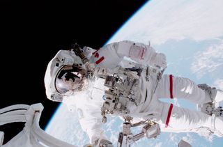 Canadian astronaut Chris Hadfield conducts a spacewalk during the STS-100 space shuttle mission in April 2001.